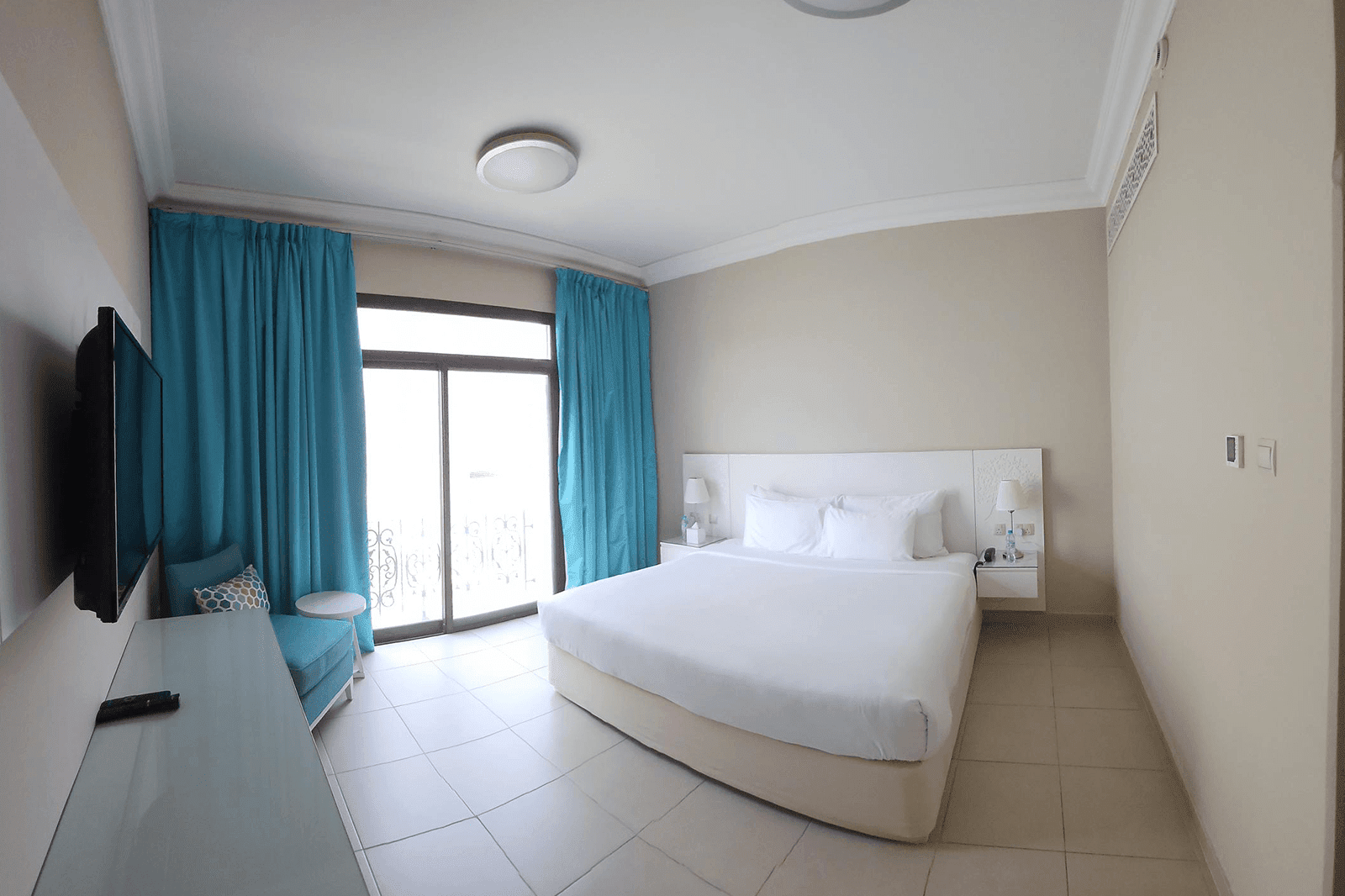 A studio room with a bed and TV