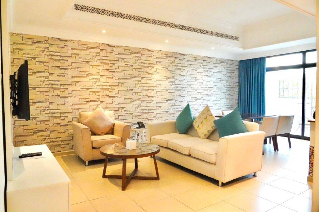 A Living Room with TV and Sofa in Andalus By Al Seef Resort and Spa
