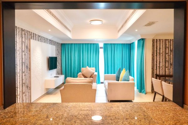 A Room with Sofas and Dining Table in Andalus By Al Seef Resort and Spa