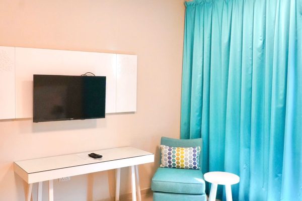 An Arm Chair and a TV in Andalus By Al Seef Resort and Spa