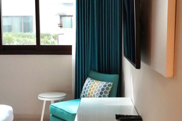 An Arm Chair and a TV in a Studio of Andalus By Al Seef Resort and Spa